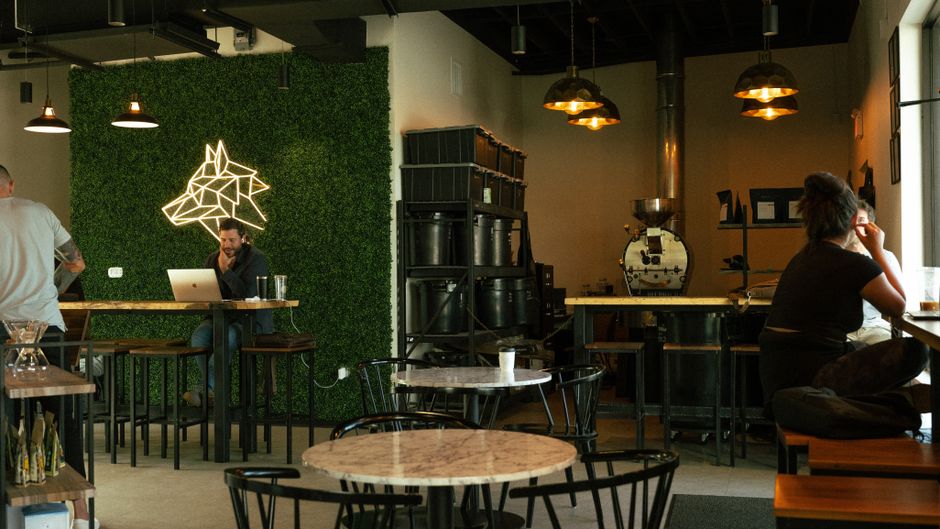 Warm and inviting coffee shop with customers working and unique interior design