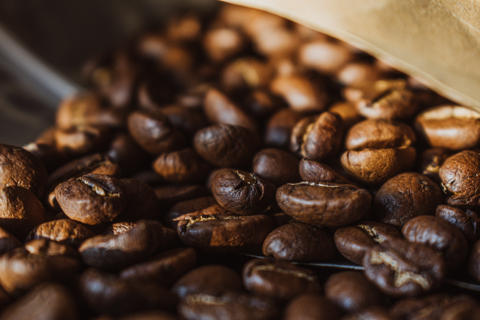 Rich, detailed close-up of aromatic roasted coffee beans showcasing texture and color